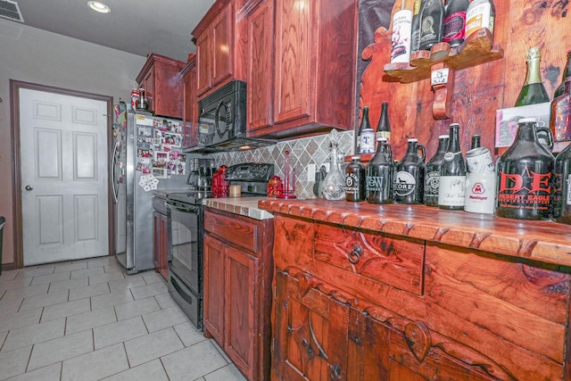 4109 Seminole Trl, Granbury, TX 76048 - kitchen featuring black appliances, decorative backsplash, light tile patterned floors, brown cabinets, and recessed lighting