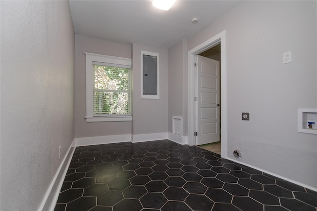 916 Wilde St, Denison, TX 75020 - tiled empty room featuring electric panel, a smoke detector, and baseboards