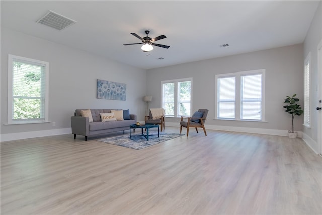 916 Wilde St, Denison, TX 75020 - living room with light wood finished floors, baseboards, and a ceiling fan