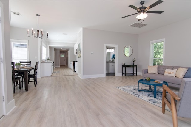 916 Wilde St, Denison, TX 75020 - living room featuring a chandelier, light wood-type flooring, a ceiling fan, and baseboards
