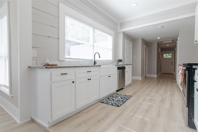 916 Wilde St, Denison, TX 75020 - kitchen with appliances with stainless steel finishes, white cabinets, a sink, light stone counters, and recessed lighting