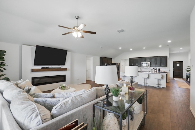 1417 Grassy Meadows Dr, Burleson, TX 76058 - living area featuring ceiling fan, recessed lighting, a glass covered fireplace, dark wood finished floors, and lofted ceiling