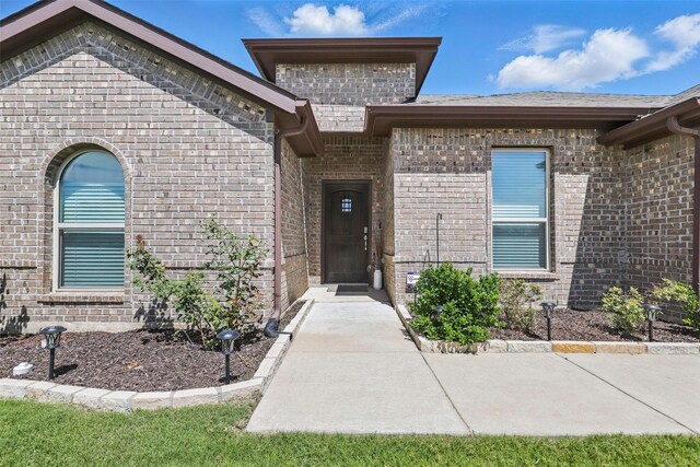 1417 Grassy Meadows Dr, Burleson, TX 76058 - view of exterior entry featuring brick siding