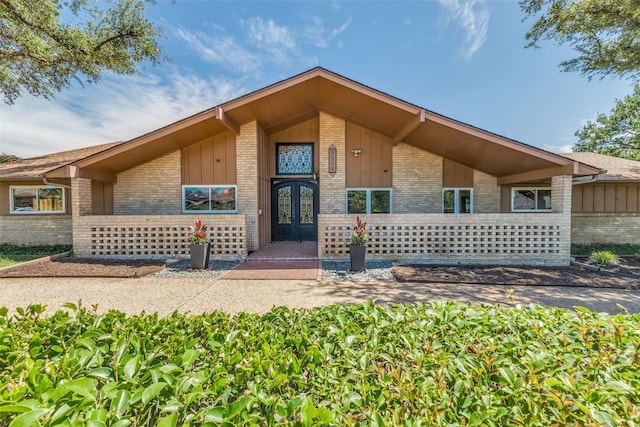 3984 Goodfellow Dr, Dallas, TX 75229 - view of front of house featuring brick siding, french doors, and board and batten siding