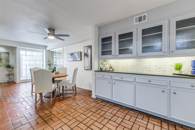 3984 Goodfellow Dr, Dallas, TX 75229 - dining space featuring brick floors, baseboards, and a ceiling fan