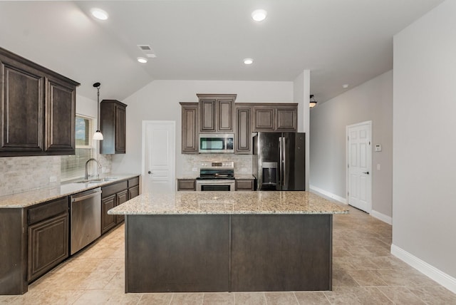 628 Cottage Pl, Lavon, TX 75166 - kitchen with stainless steel appliances, dark brown cabinetry, decorative backsplash, a sink, and a kitchen island