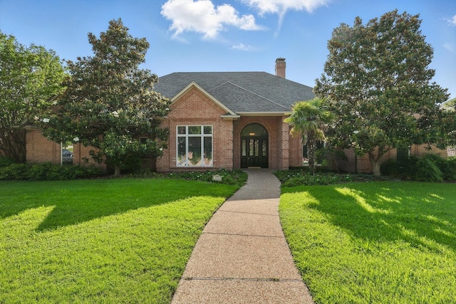5020 Still Meadow Dr, Fort Worth, TX 76132 - traditional-style home with a front yard, brick siding, a chimney, and a shingled roof