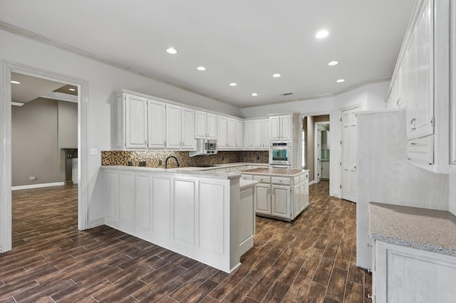 5020 Still Meadow Dr, Fort Worth, TX 76132 - kitchen featuring stainless steel appliances, crown molding, white cabinets, baseboards, and tasteful backsplash
