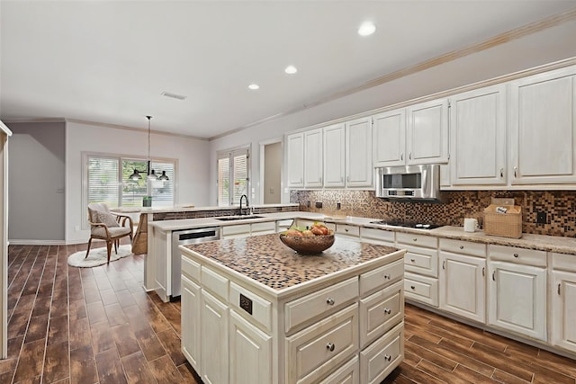 5020 Still Meadow Dr, Fort Worth, TX 76132 - kitchen with a sink, stainless steel microwave, crown molding, a peninsula, and dark wood-style flooring
