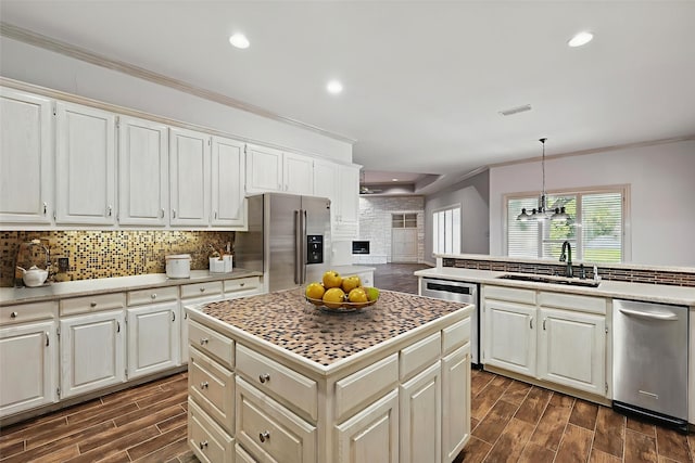 5020 Still Meadow Dr, Fort Worth, TX 76132 - kitchen featuring stainless steel appliances, a sink, a kitchen island, ornamental molding, and tasteful backsplash
