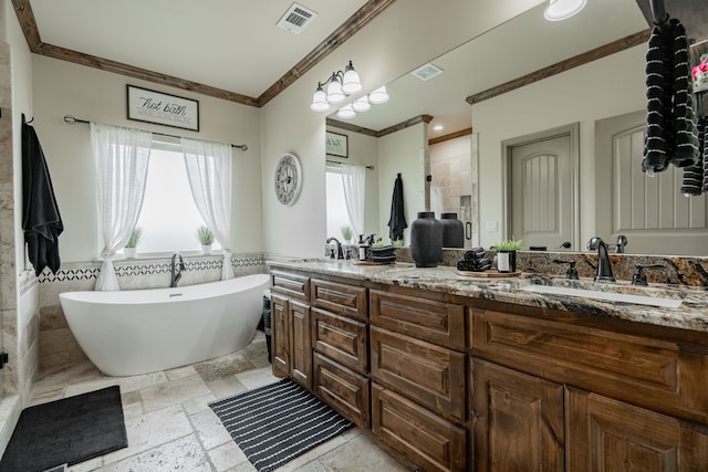 3547 County Road 1092, Celeste, TX 75423 - bathroom with ornamental molding, double vanity, stone tile floors, a freestanding tub, and a wainscoted wall