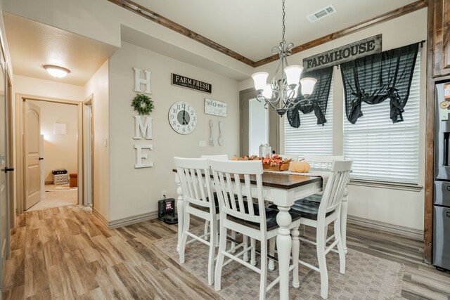 3547 County Road 1092, Celeste, TX 75423 - dining space with a chandelier, light wood-style flooring, and baseboards