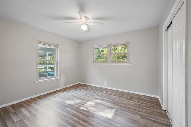 1043 Star St, Denison, TX 75020 - unfurnished bedroom with a closet, wood finished floors, baseboards, and a ceiling fan