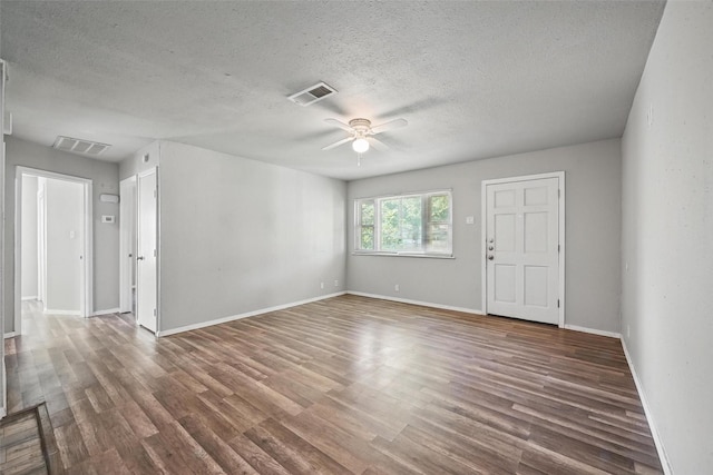 1043 Star St, Denison, TX 75020 - spare room with ceiling fan, a textured ceiling, wood finished floors, and baseboards