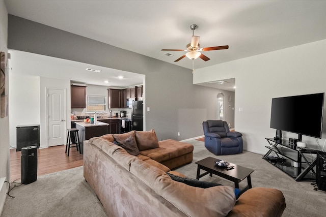 113 Hamilton Way, Venus, TX 76084 - living room featuring light colored carpet, a ceiling fan, and arched walkways