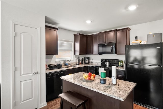 113 Hamilton Way, Venus, TX 76084 - kitchen with black appliances, dark brown cabinetry, a sink, wood finished floors, and a kitchen island