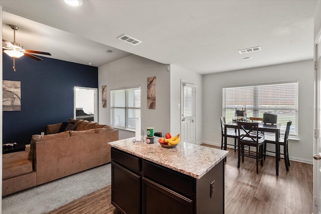 113 Hamilton Way, Venus, TX 76084 - kitchen featuring wood finished floors, open floor plan, ceiling fan, a kitchen island, and baseboards