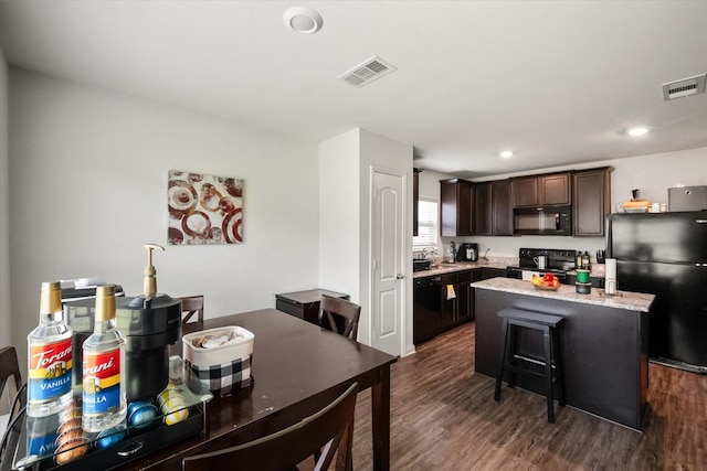 113 Hamilton Way, Venus, TX 76084 - kitchen featuring black appliances, dark brown cabinetry, a kitchen island, dark wood-style floors, and a sink