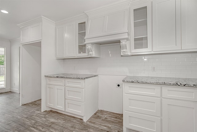 3408 Walton Ave, Fort Worth, TX 76133 - kitchen with light stone countertops, decorative backsplash, light wood-style floors, white cabinetry, and recessed lighting