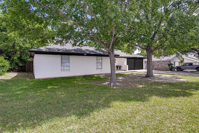3408 Walton Ave, Fort Worth, TX 76133 - rear view of property featuring concrete driveway, an attached garage, brick siding, and a yard