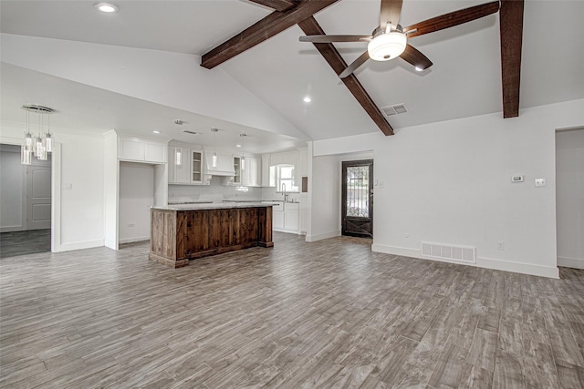 3408 Walton Ave, Fort Worth, TX 76133 - unfurnished living room featuring beam ceiling, ceiling fan, light wood-style floors, a sink, and baseboards