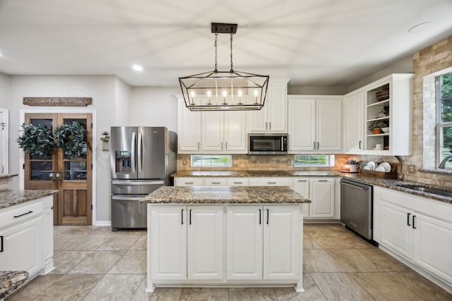 18818 Webb Ln, Nevada, TX 75173 - kitchen featuring appliances with stainless steel finishes, a sink, decorative backsplash, and white cabinetry