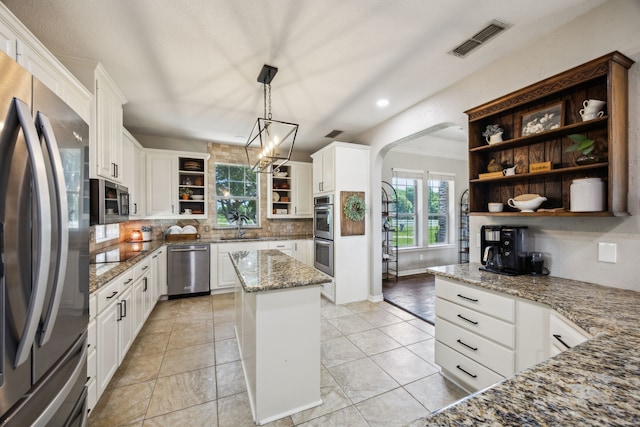 18818 Webb Ln, Nevada, TX 75173 - kitchen with open shelves, appliances with stainless steel finishes, a sink, backsplash, and light stone counters