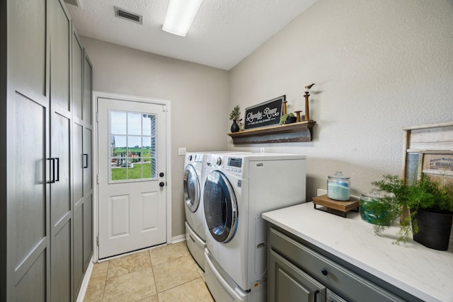 18818 Webb Ln, Nevada, TX 75173 - laundry room featuring washer and dryer, cabinet space, a textured ceiling, and light tile patterned flooring