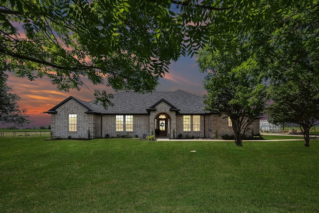 18818 Webb Ln, Nevada, TX 75173 - view of front of house featuring a front yard, a shingled roof, and brick siding