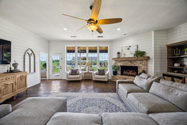 18818 Webb Ln, Nevada, TX 75173 - living area with dark wood-style floors, ceiling fan, a textured ceiling, wood walls, and a fireplace