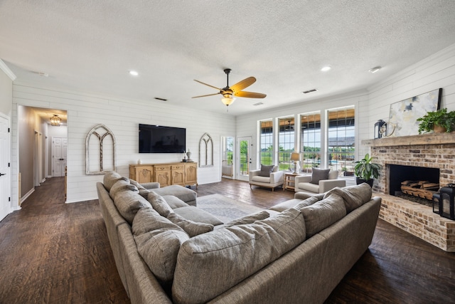 18818 Webb Ln, Nevada, TX 75173 - living room featuring a textured ceiling, a ceiling fan, dark wood-style floors, a fireplace, and recessed lighting