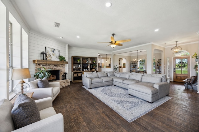 18818 Webb Ln, Nevada, TX 75173 - living room featuring arched walkways, ornamental molding, a fireplace, dark wood-style floors, and ceiling fan