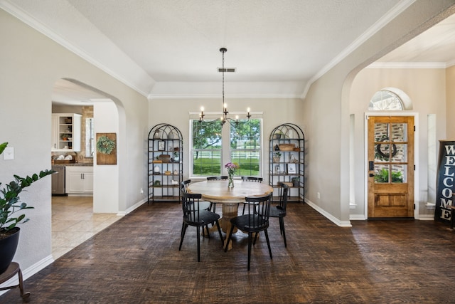18818 Webb Ln, Nevada, TX 75173 - dining space with arched walkways, a chandelier, ornamental molding, baseboards, and wood finished floors