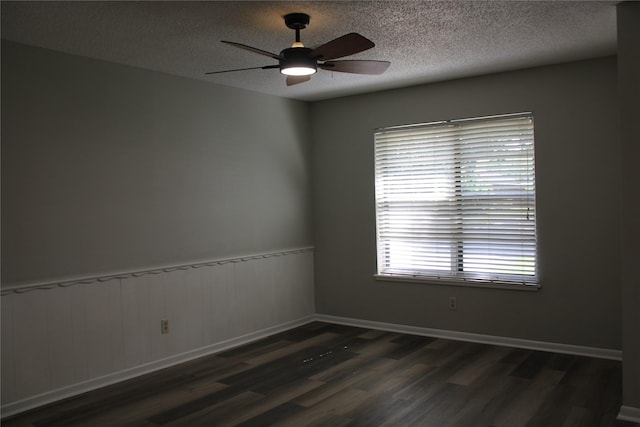 3026 San Miguel Dr, Abilene, TX 79605 - spare room featuring wood finished floors, a textured ceiling, a ceiling fan, and a wainscoted wall