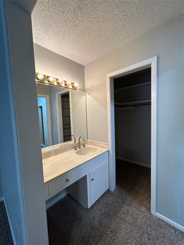 3026 San Miguel Dr, Abilene, TX 79605 - bathroom with a textured ceiling and vanity