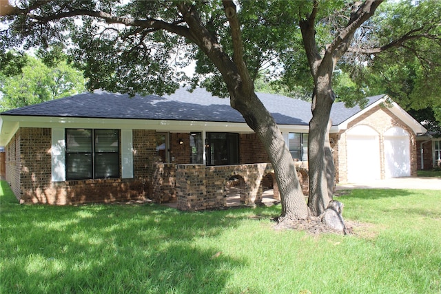 3026 San Miguel Dr, Abilene, TX 79605 - ranch-style home featuring brick siding, a front lawn, and a shingled roof