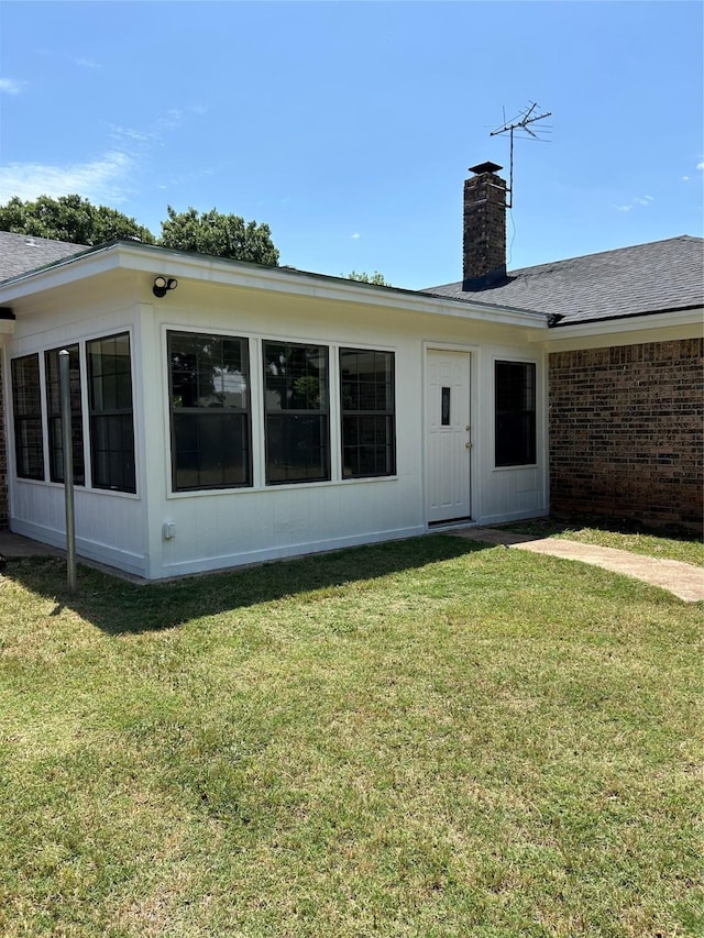 3026 San Miguel Dr, Abilene, TX 79605 - back of property with a lawn, a chimney, and a shingled roof