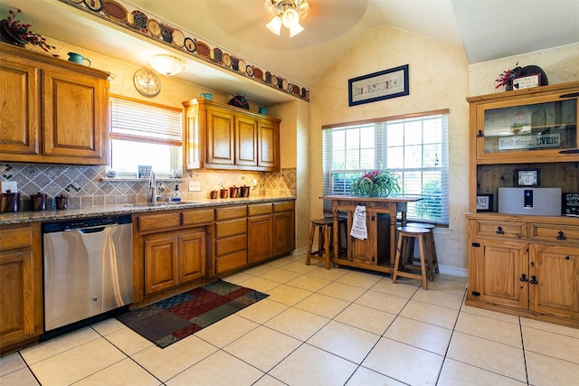 279 County Road 3470, Paradise, TX 76073 - kitchen featuring dishwasher, a sink, vaulted ceiling, brown cabinetry, and a ceiling fan