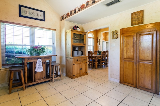 279 County Road 3470, Paradise, TX 76073 - kitchen featuring lofted ceiling, open shelves, light tile patterned floors, and a textured wall
