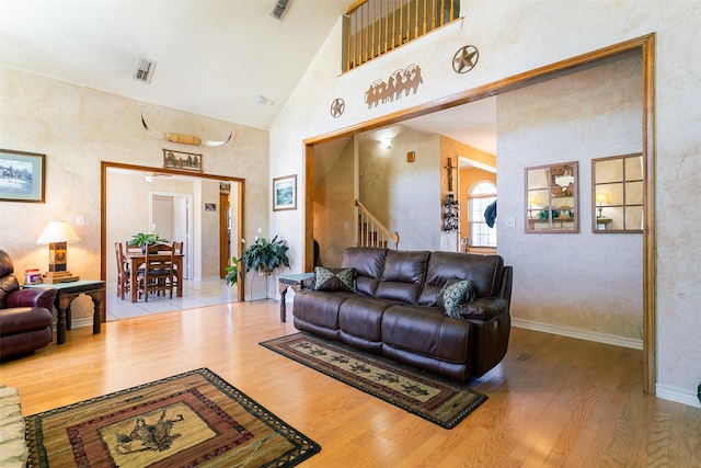 279 County Road 3470, Paradise, TX 76073 - living area with high vaulted ceiling, wood finished floors, stairs, and baseboards