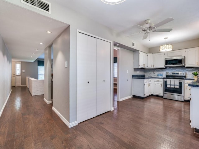 4552 Fremont Ln, Plano, TX 75093 - kitchen with stainless steel appliances, dark countertops, ceiling fan, white cabinetry, and backsplash