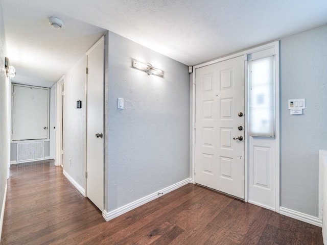 4552 Fremont Ln, Plano, TX 75093 - entrance foyer with dark wood-type flooring, baseboards, and a textured wall