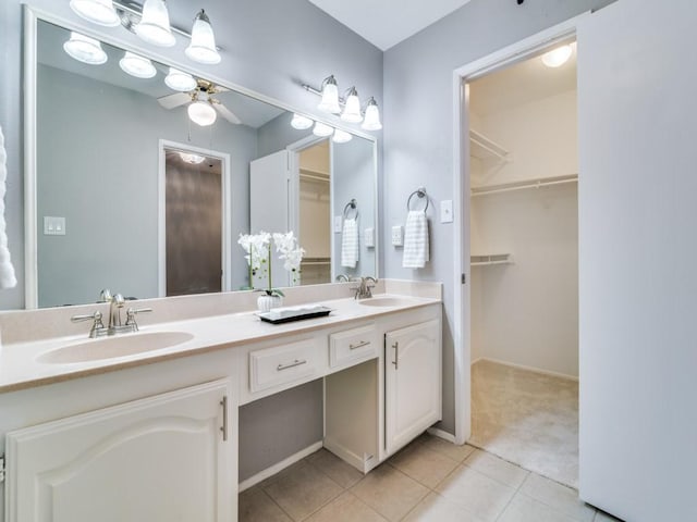 4552 Fremont Ln, Plano, TX 75093 - bathroom with double vanity, ceiling fan, tile patterned flooring, and a walk in closet