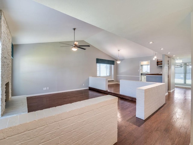 4552 Fremont Ln, Plano, TX 75093 - unfurnished living room featuring plenty of natural light, dark wood-type flooring, vaulted ceiling, and a ceiling fan
