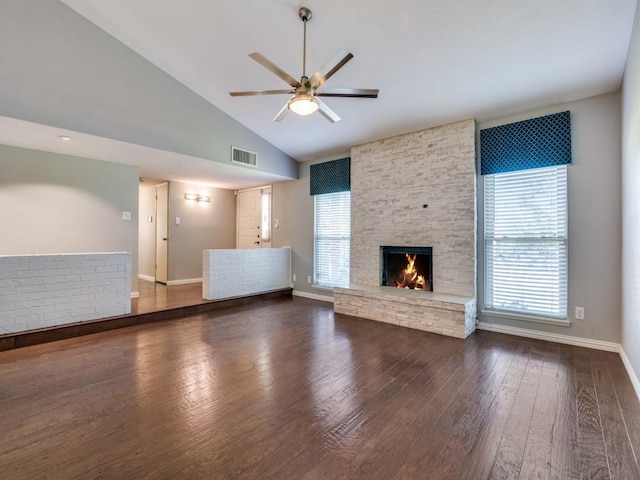 4552 Fremont Ln, Plano, TX 75093 - unfurnished living room featuring ceiling fan, wood finished floors, a stone fireplace, baseboards, and high vaulted ceiling