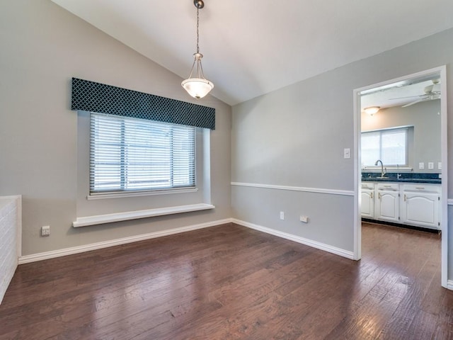 4552 Fremont Ln, Plano, TX 75093 - unfurnished dining area featuring dark wood-type flooring, lofted ceiling, a ceiling fan, baseboards, and a sink