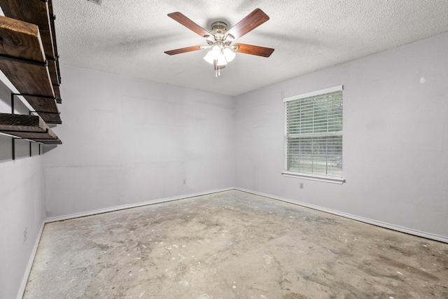 453 County Road 2521, Bonham, TX 75418 - spare room featuring unfinished concrete floors, ceiling fan, baseboards, and a textured ceiling