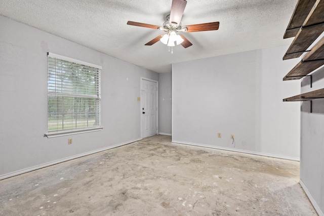 453 County Road 2521, Bonham, TX 75418 - unfurnished living room with unfinished concrete flooring, a ceiling fan, a textured ceiling, and baseboards