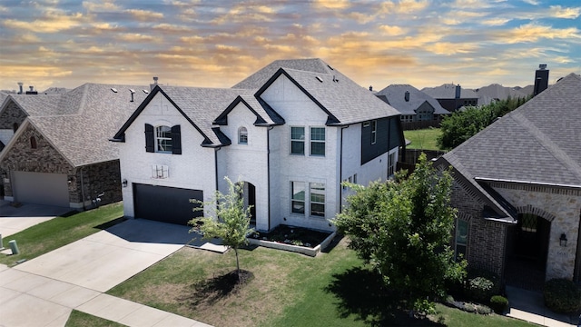 664 Fletcher Dr, Fate, TX 75087 - french country home with concrete driveway, a garage, a front lawn, brick siding, and a residential view