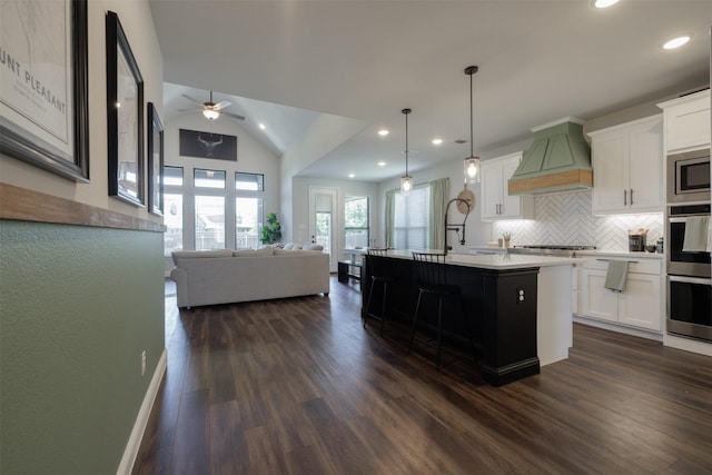 664 Fletcher Dr, Fate, TX 75087 - kitchen featuring premium range hood, a ceiling fan, backsplash, open floor plan, and recessed lighting